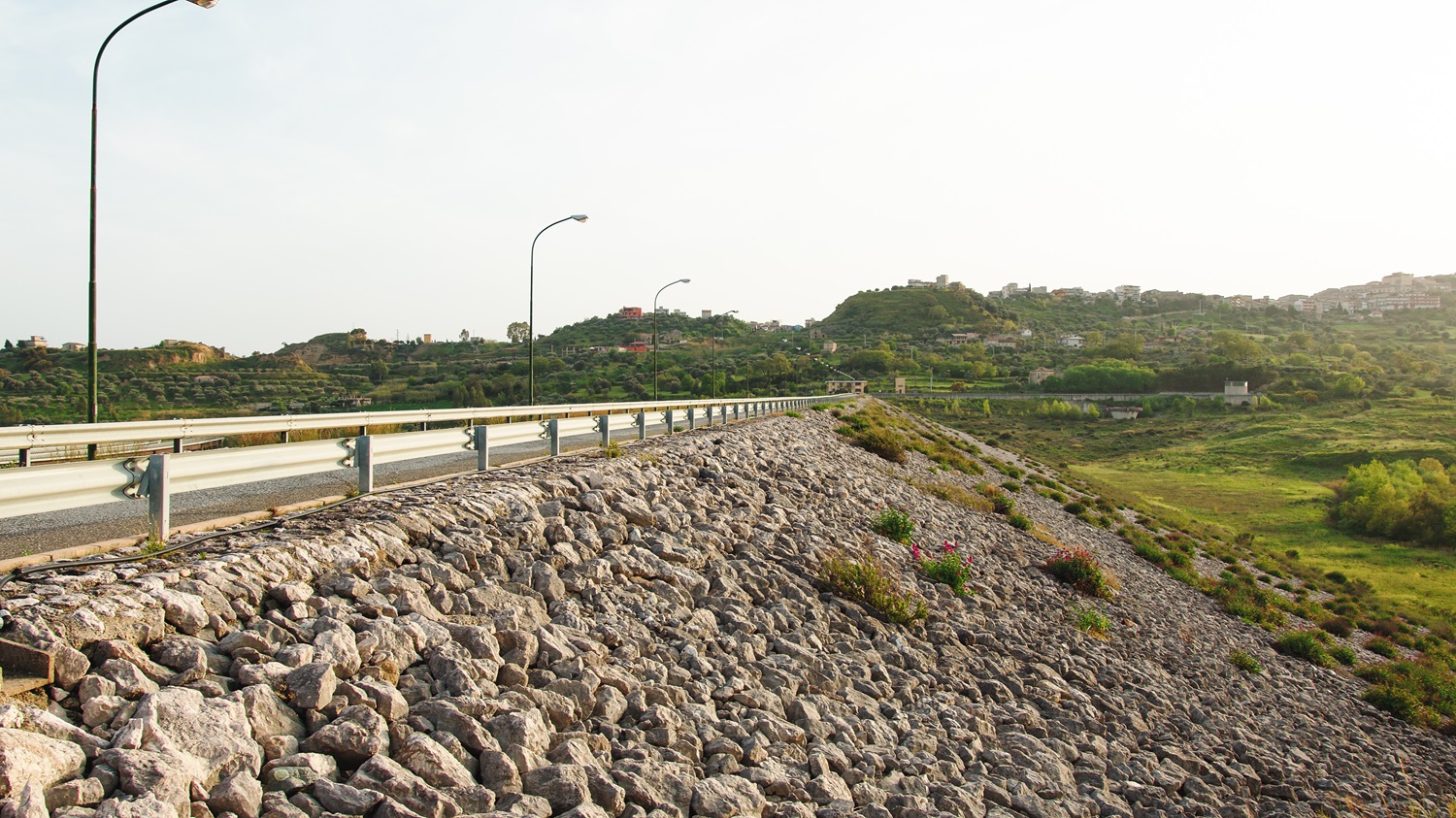 a road with rocks and grass